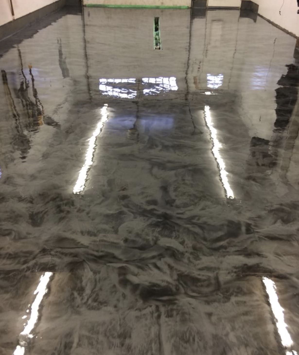 Silver metallic epoxy floor in an industrial space by Titan Floor Systems