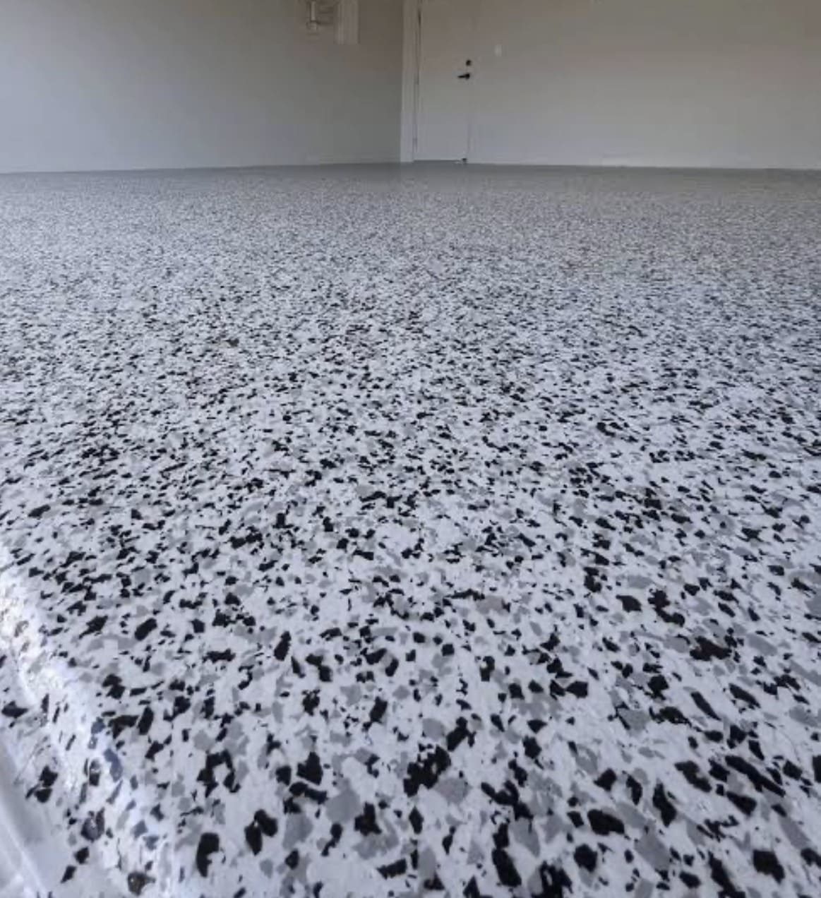 White and grey flake epoxy floor in a residential room, Titan Floor Systems